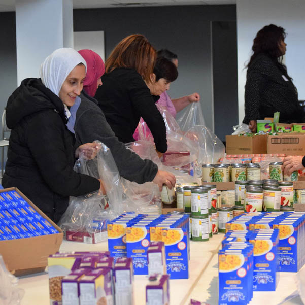 Women gathering food items for local families.