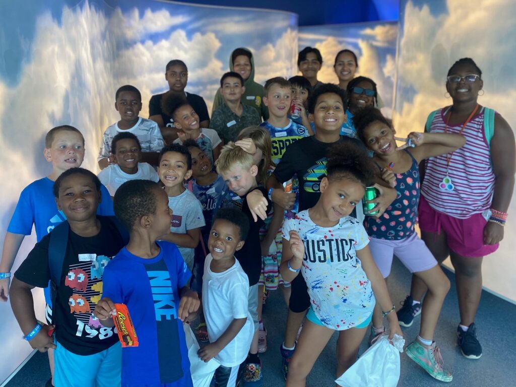 A group of children gather near the entrance to the Kalamazoo Air Zoo.