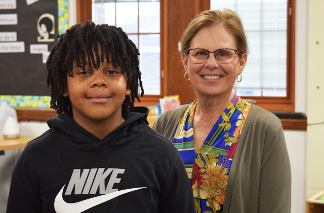 Fifth-grader Chondell stands next to his tutor, Kathy.