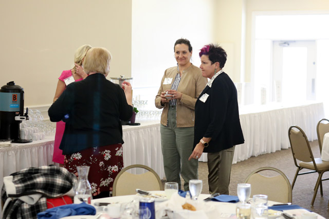 Four people standing and talking.