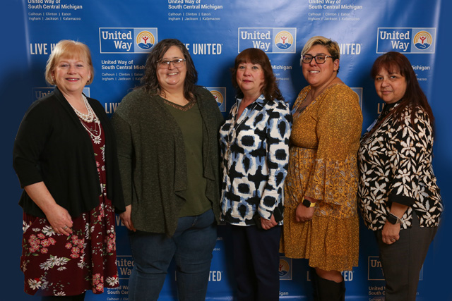 Five women pose in front of United Way backdrop