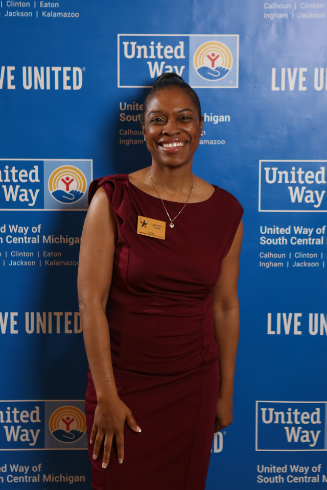 Woman poses in front of United Way backdrop