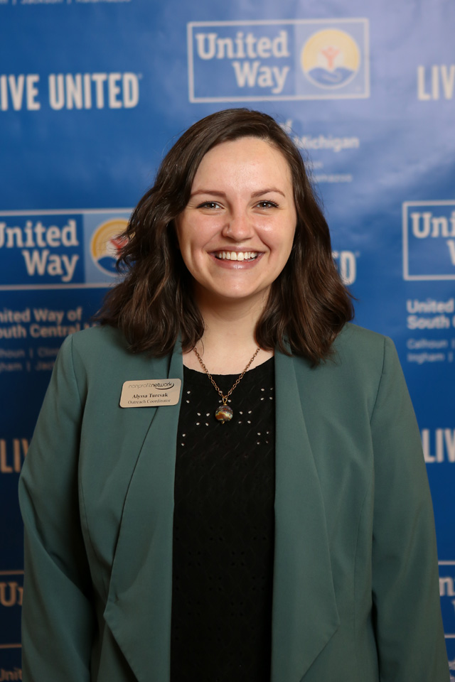 Woman poses in front of United Way backdrop