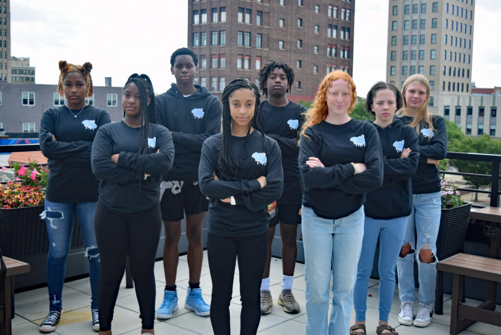 Eight teens stand in formation.