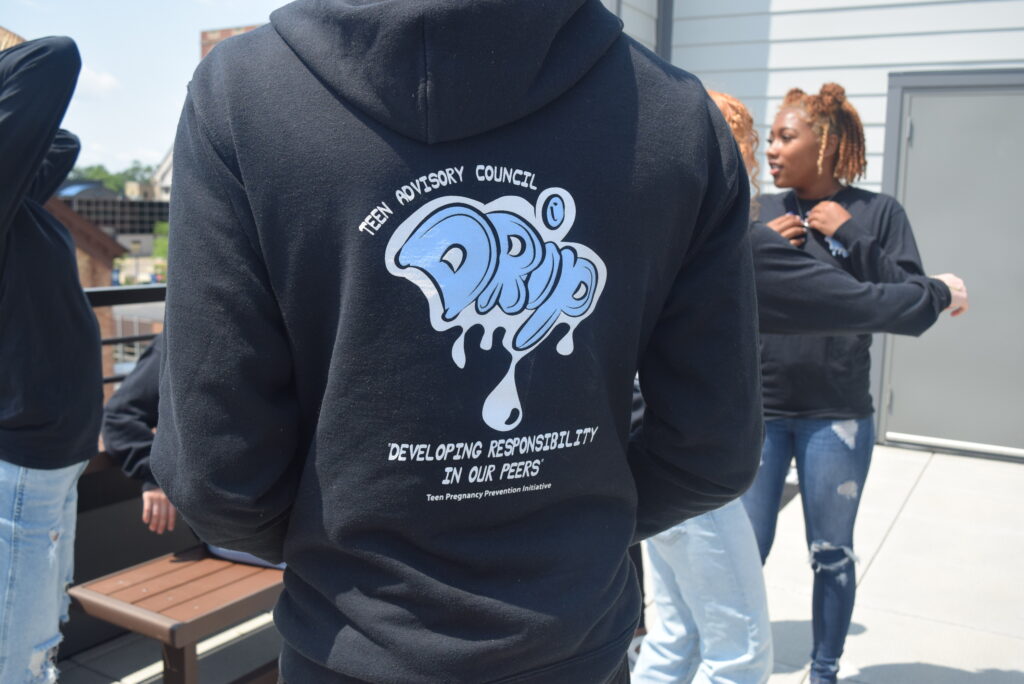 Text on black sweatshirt reads: Teen Advisory Council DRIP: Developing Responsibility in our Peers.
