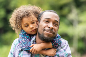 Black Father and daughter having fun together in a public park