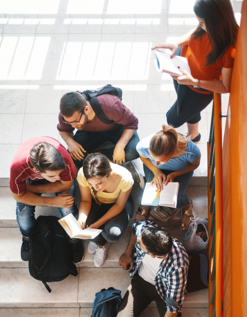 A group of students gather on a staircase.