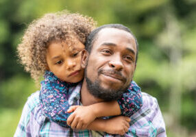 Black Father and daughter having fun together in a public park